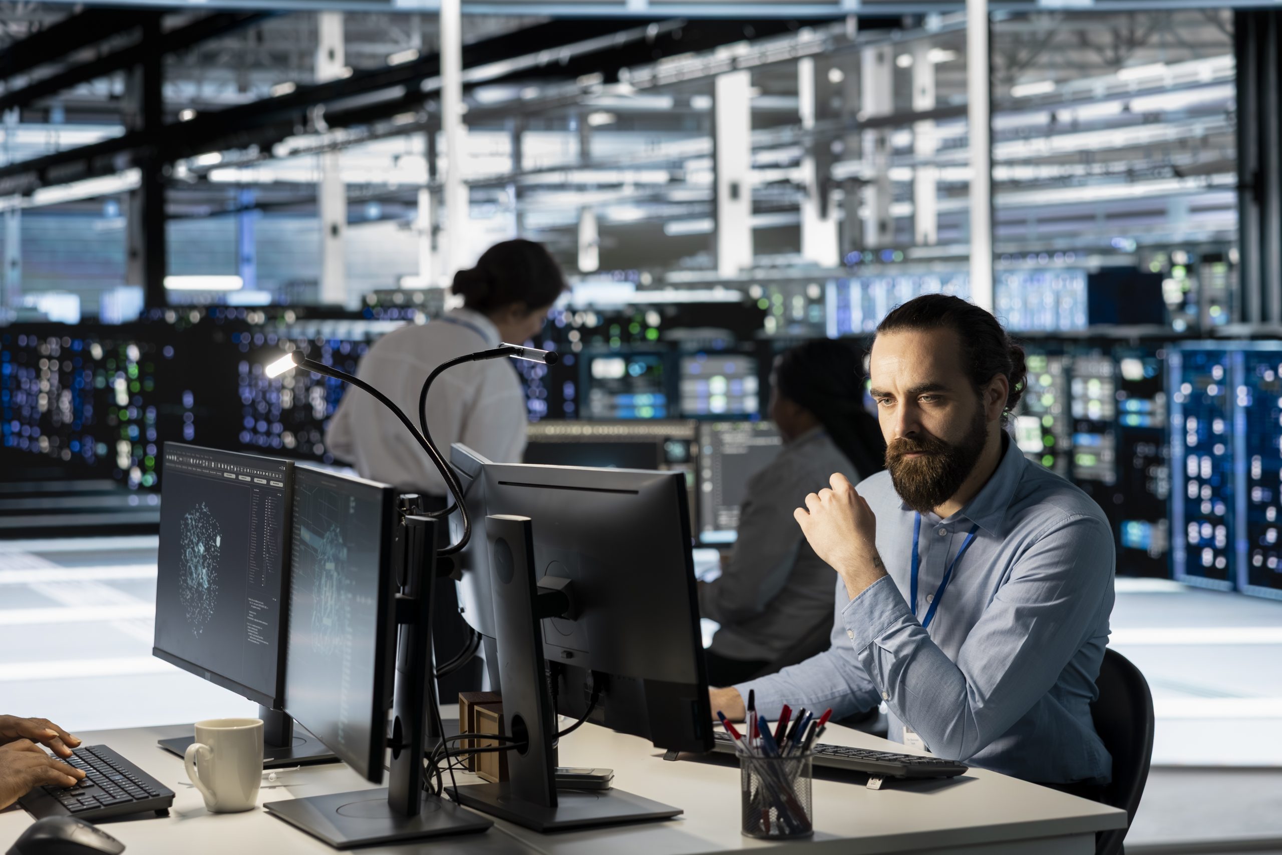 Technician using PC in data center to update server tech, configuring equipment